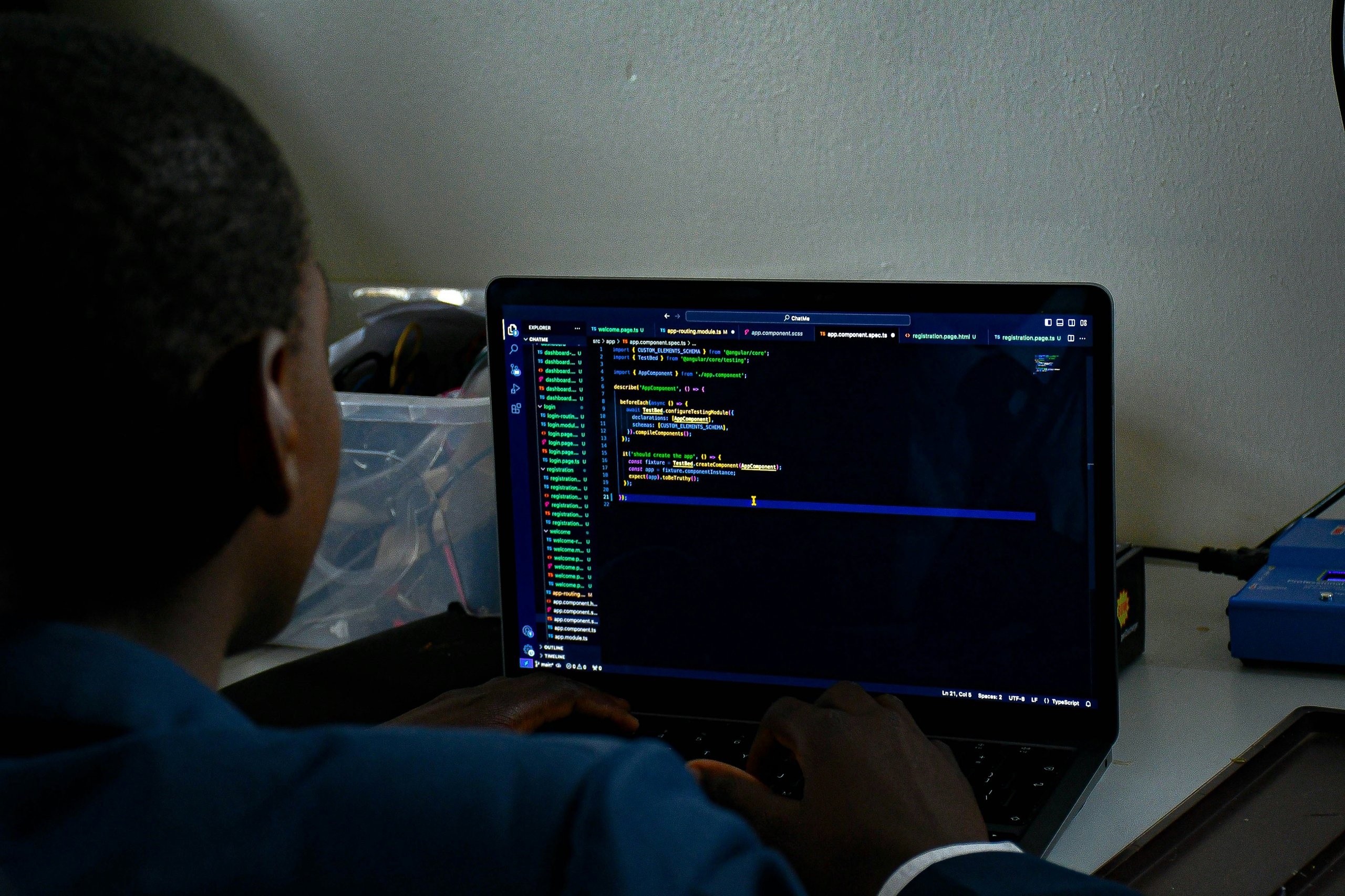 Analyst reviewing code on a laptop
